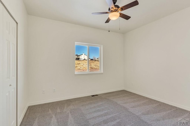 spare room with light carpet, visible vents, and baseboards