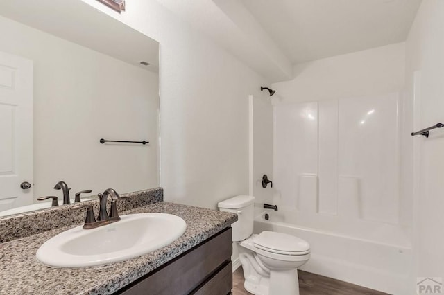 full bath featuring shower / bathing tub combination, vanity, toilet, and wood finished floors