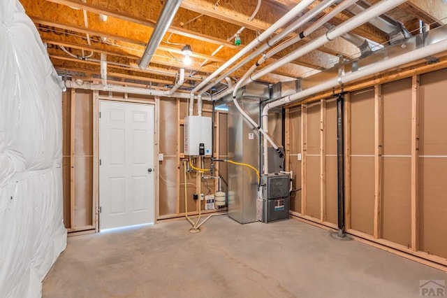 unfinished basement featuring heating unit and tankless water heater