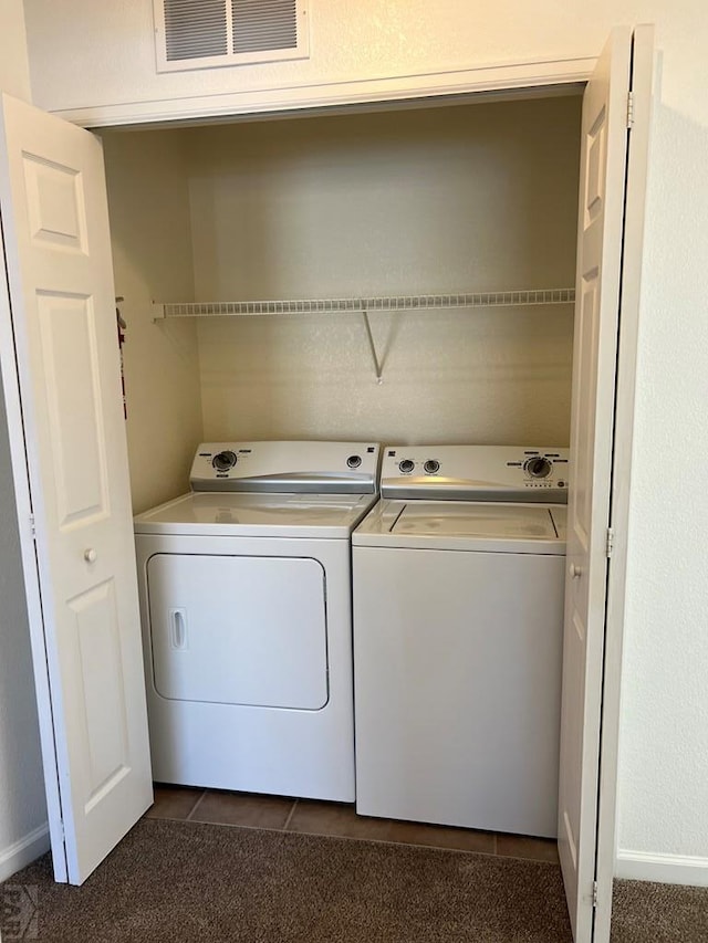 washroom featuring laundry area, washing machine and dryer, and visible vents