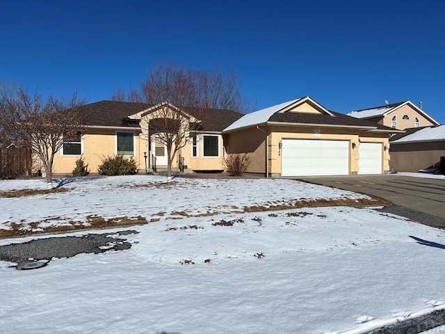 single story home with a garage, concrete driveway, and stucco siding