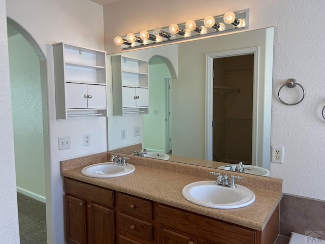 full bath featuring double vanity and a sink