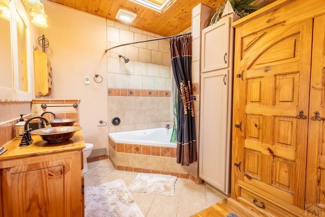 full bathroom featuring toilet, wood ceiling, vanity, tiled shower / bath, and tile patterned floors