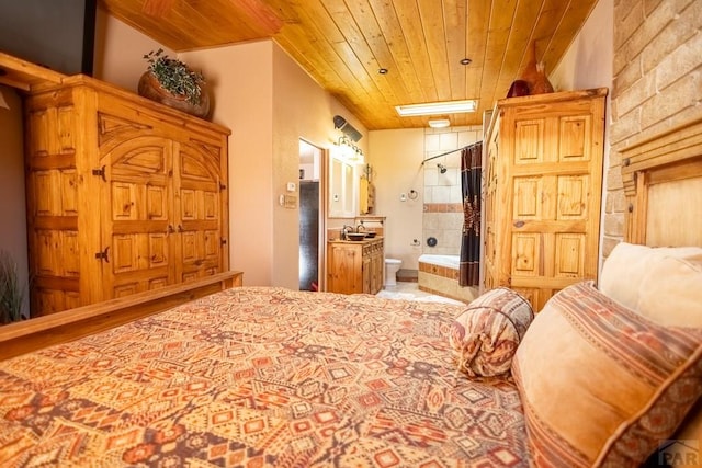 bedroom with a skylight, wooden ceiling, a sink, and ensuite bathroom