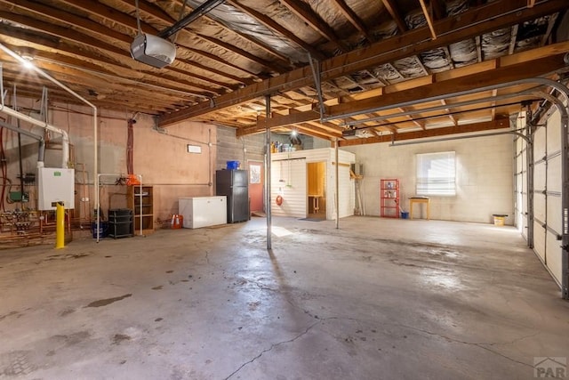 garage with freestanding refrigerator and a garage door opener