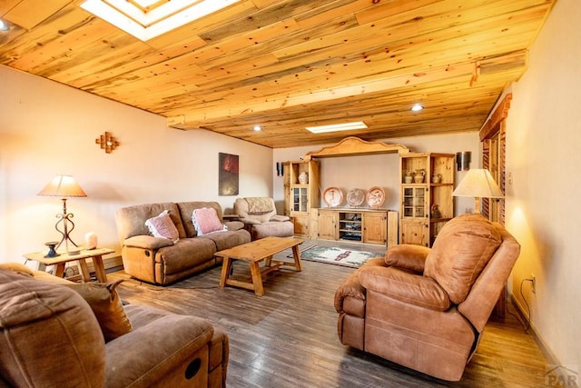 living area featuring lofted ceiling with skylight, wood ceiling, and wood finished floors