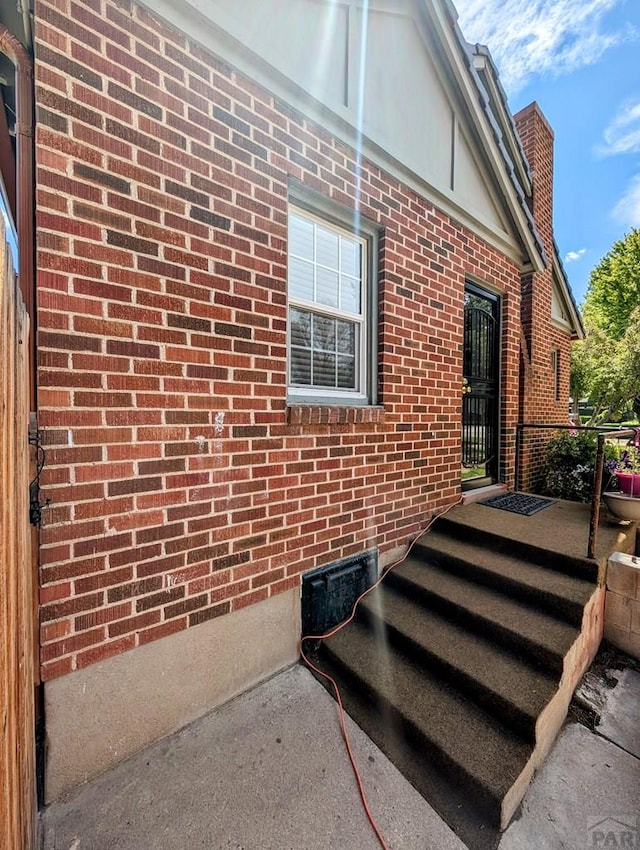 property entrance with brick siding