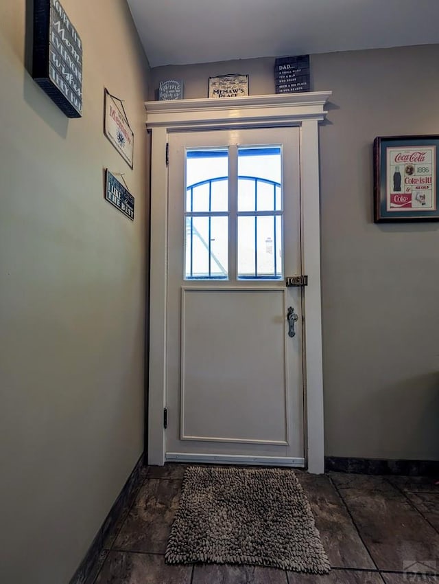 doorway to outside with baseboards