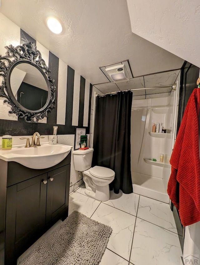 bathroom with a stall shower, marble finish floor, vanity, and toilet