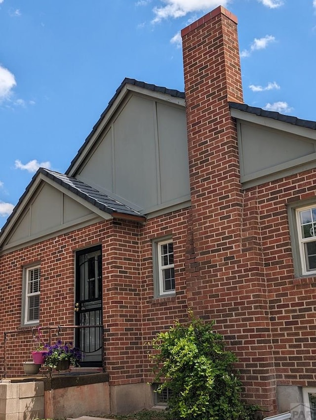 view of side of property featuring brick siding