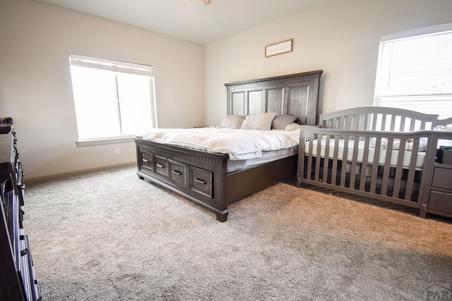 bedroom with light carpet and baseboards