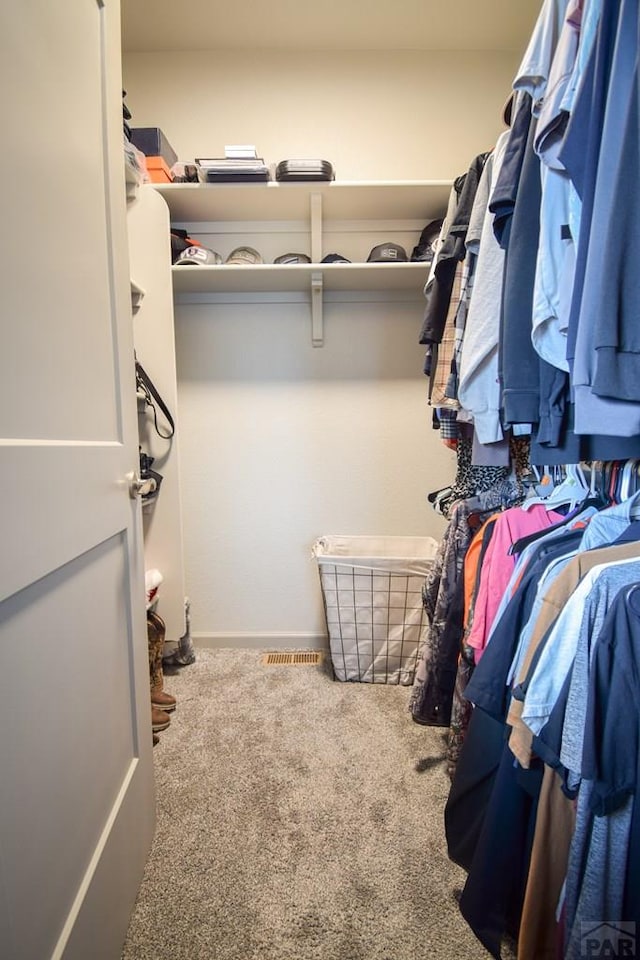 walk in closet featuring carpet