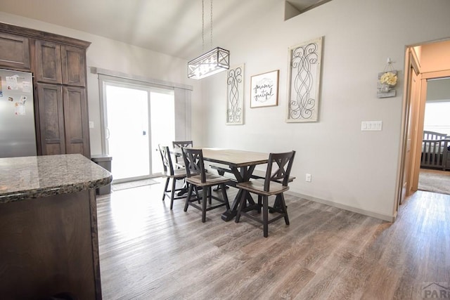 dining area featuring baseboards and wood finished floors