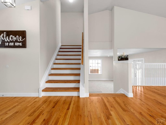 stairs with baseboards and wood finished floors