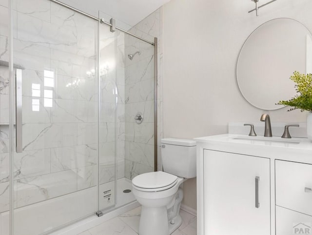 full bath featuring marble finish floor, a marble finish shower, toilet, vanity, and baseboards