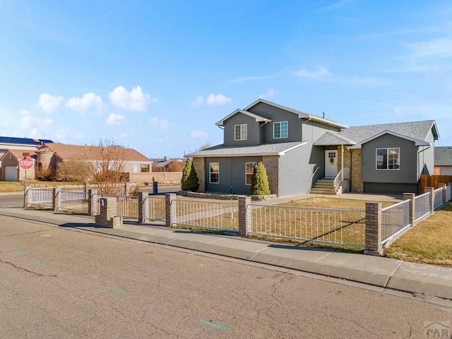 view of front of home featuring a fenced front yard and a residential view