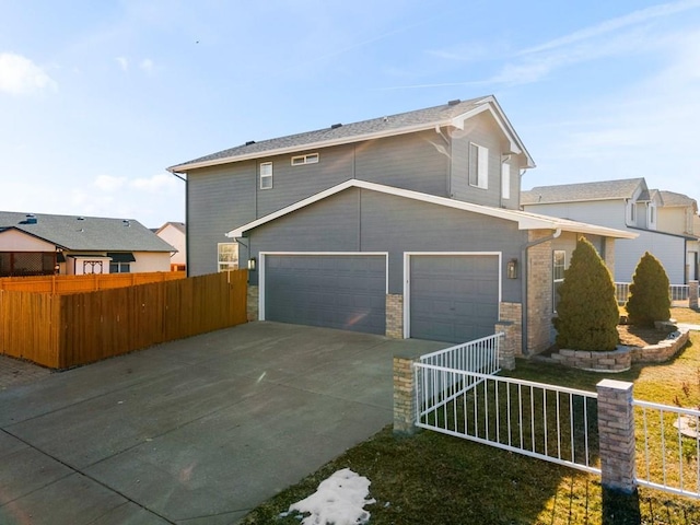 view of front of home with driveway, a garage, and fence