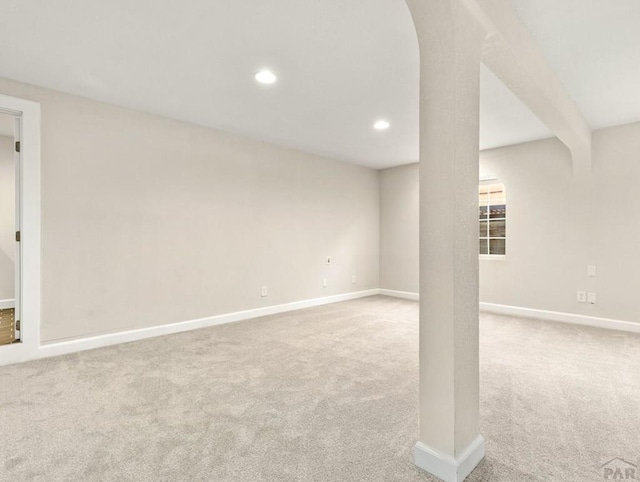 basement featuring recessed lighting, baseboards, and light colored carpet