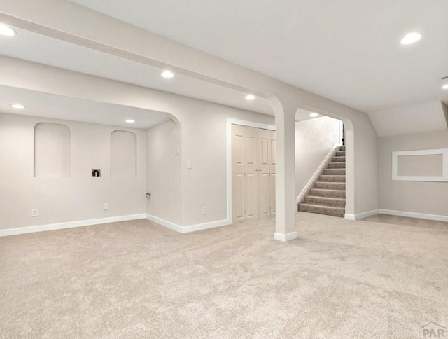 basement with light carpet, stairway, recessed lighting, and baseboards