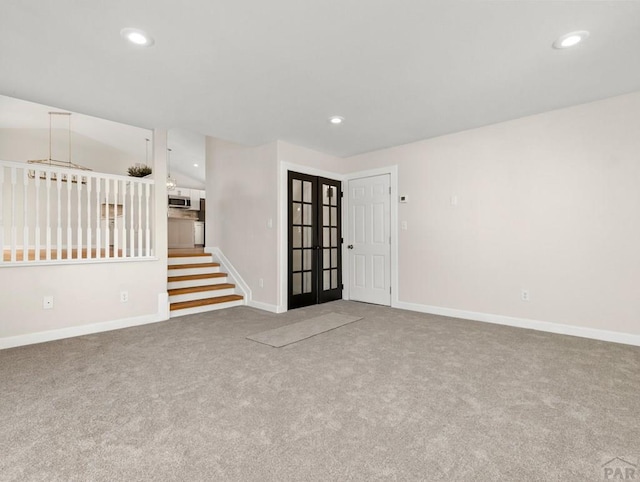 carpeted spare room featuring baseboards, french doors, and recessed lighting