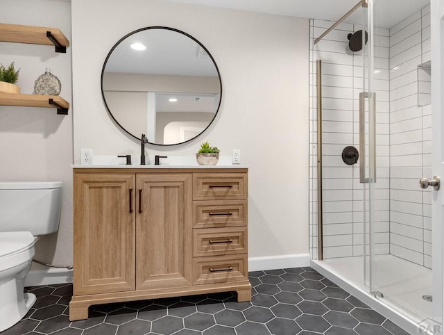 full bathroom with toilet, a shower stall, vanity, baseboards, and tile patterned floors