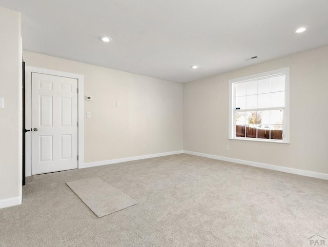 unfurnished room featuring baseboards, recessed lighting, and light colored carpet