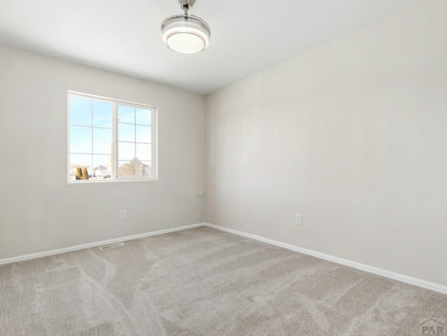 empty room with light carpet, baseboards, and visible vents