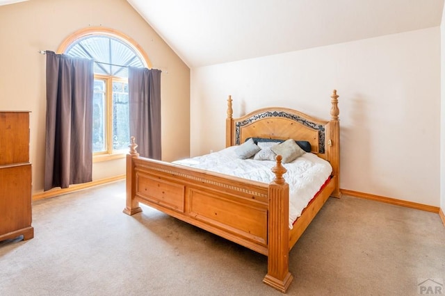 carpeted bedroom featuring vaulted ceiling and baseboards