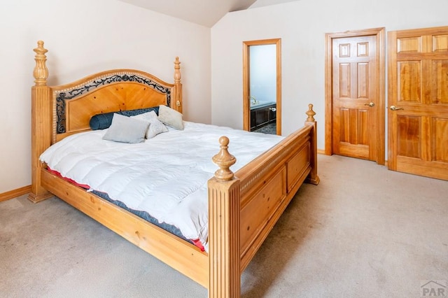 bedroom featuring lofted ceiling, baseboards, and light colored carpet