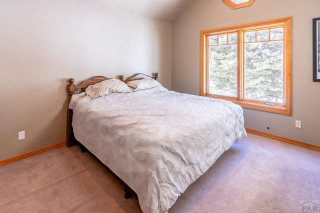 bedroom featuring lofted ceiling, baseboards, and light colored carpet