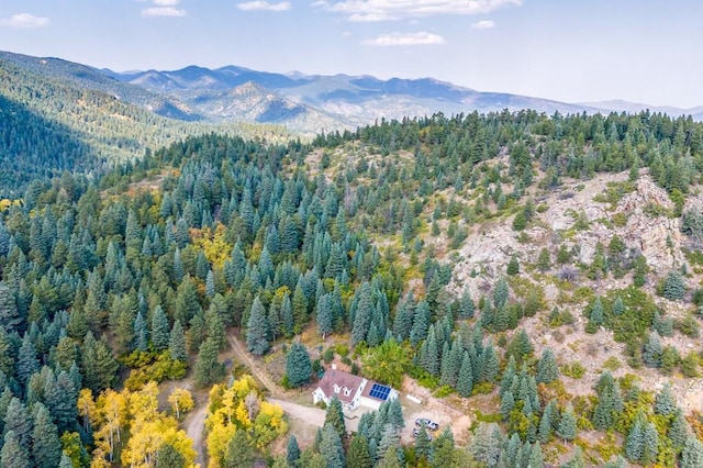 drone / aerial view with a forest view and a mountain view