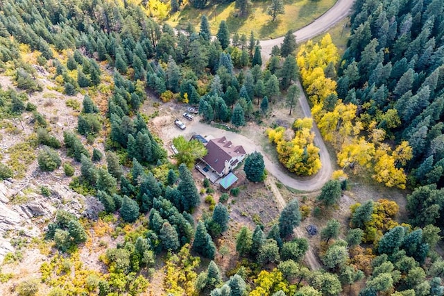 birds eye view of property with a view of trees