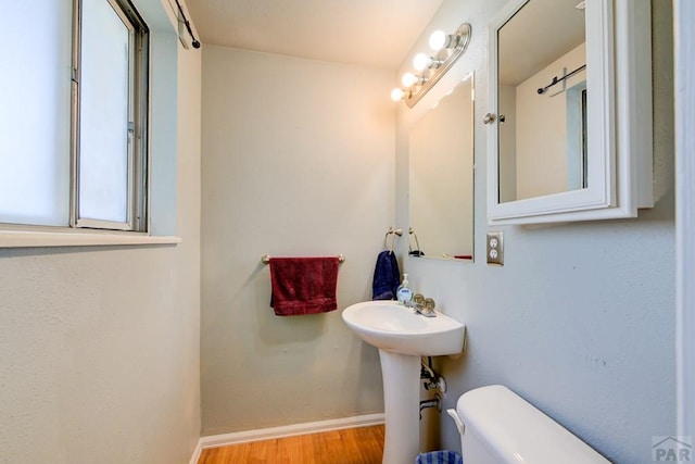 4465 London Ln, Colorado Springs, CO 80916 - bathroom featuring toilet, baseboards, and wood finished floors