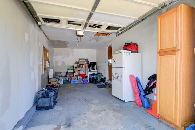 4465 London Ln, Colorado Springs, CO 80916 - garage with freestanding refrigerator and a garage door opener