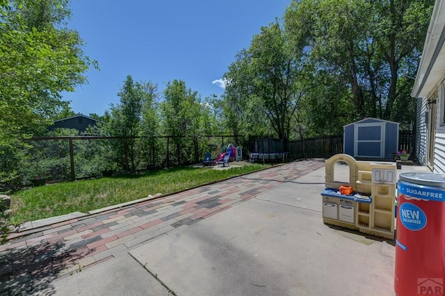 4465 London Ln, Colorado Springs, CO 80916 - fenced backyard with a patio area and a trampoline