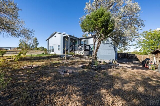 rear view of property with fence