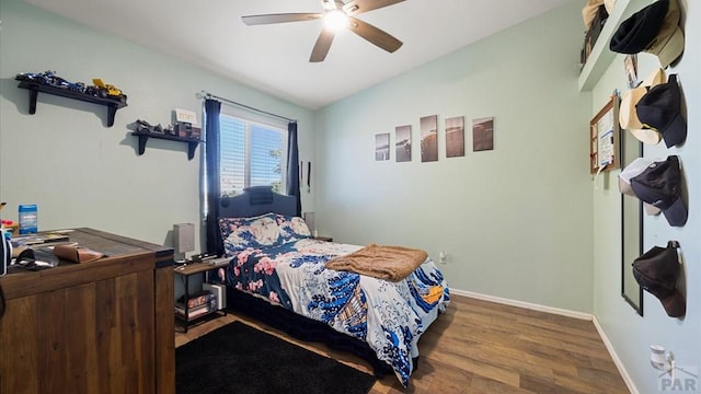 bedroom featuring baseboards, ceiling fan, and wood finished floors
