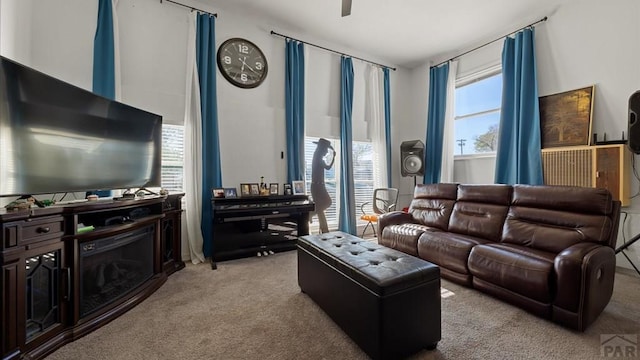 living room featuring ceiling fan and carpet flooring