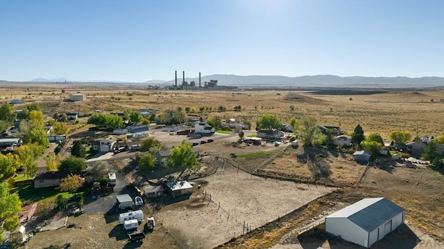 drone / aerial view with a mountain view, a desert view, and a rural view