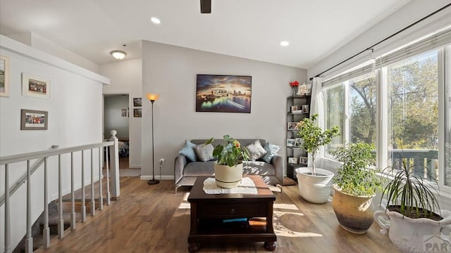sitting room featuring baseboards, vaulted ceiling, recessed lighting, an upstairs landing, and wood finished floors