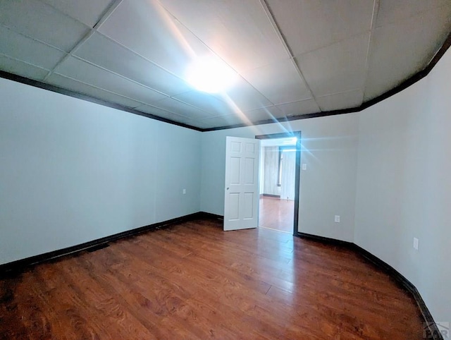 428 Elm Ave, Las Animas, CO 81054 - unfurnished room featuring dark wood-style floors and a drop ceiling