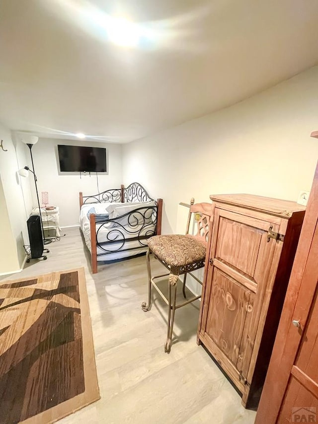 bedroom featuring light wood-style flooring and baseboards