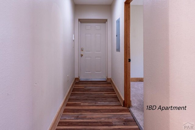 interior space with dark wood-style flooring and baseboards