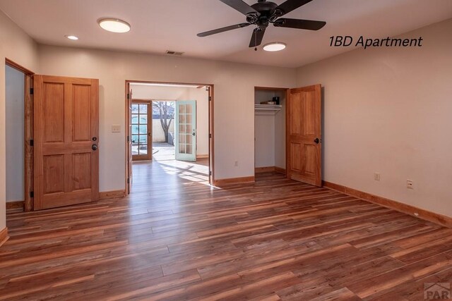 interior space featuring dark wood-type flooring, french doors, visible vents, and baseboards