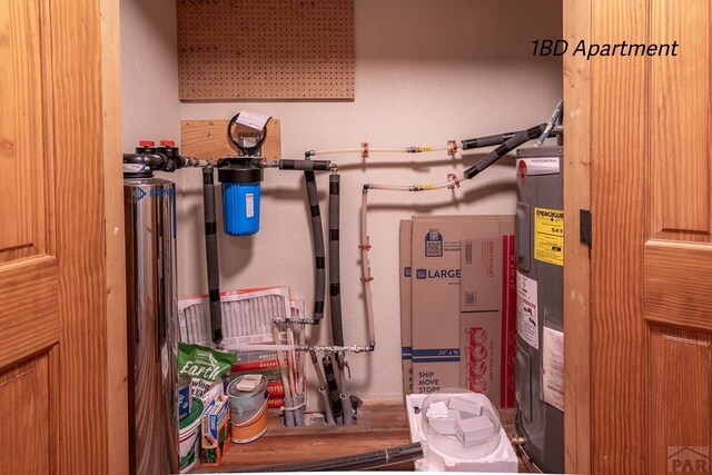 utility room featuring water heater