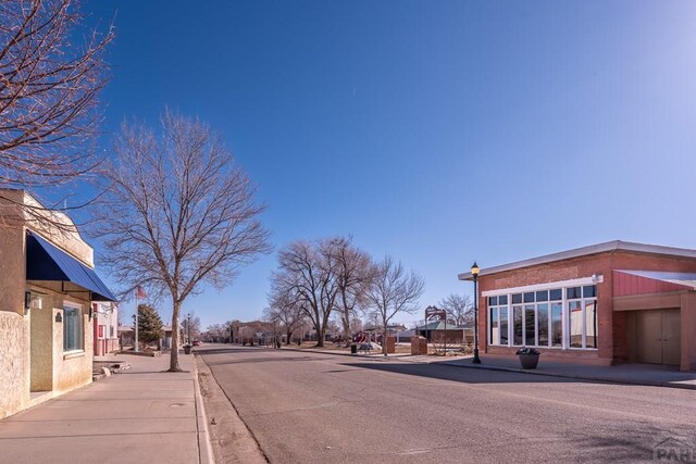 view of road with sidewalks and curbs