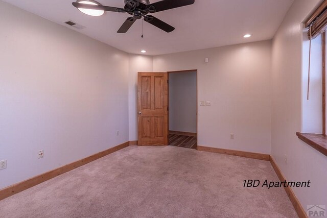 carpeted spare room with a ceiling fan, recessed lighting, visible vents, and baseboards