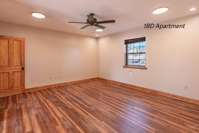 spare room featuring ceiling fan, recessed lighting, dark wood finished floors, and baseboards