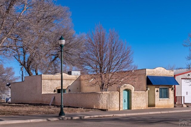 exterior space featuring a fenced front yard and stucco siding