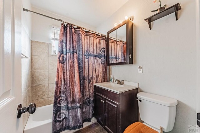 full bathroom with vanity, toilet, and shower / bath combo with shower curtain